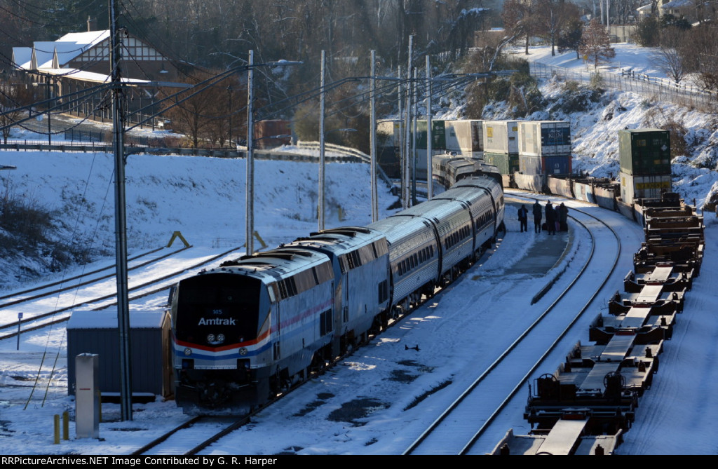 A few passengers on #20(2) mill about on the platform at Lynchburg